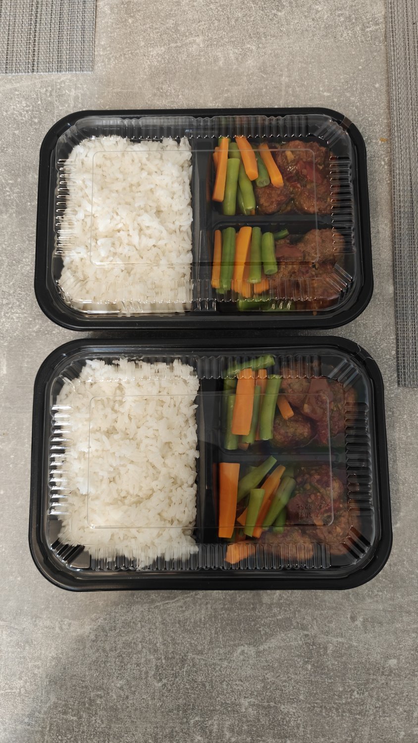 Indonesian beef steak with rice and vegetables in bento boxes